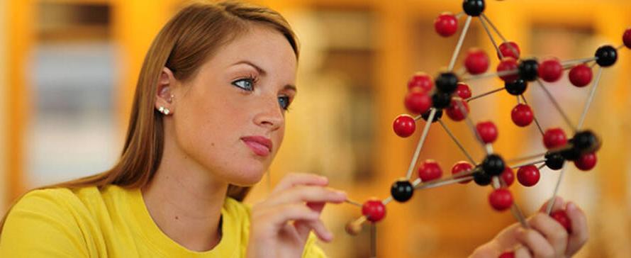 Photo of student working on model of molecules